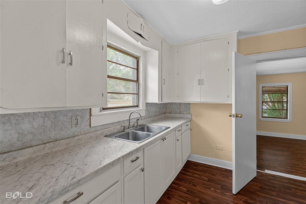 115 Pam Street Mansfield, LA 71052 - Photo 9 of 25 a kitchen with a sink and cabinets