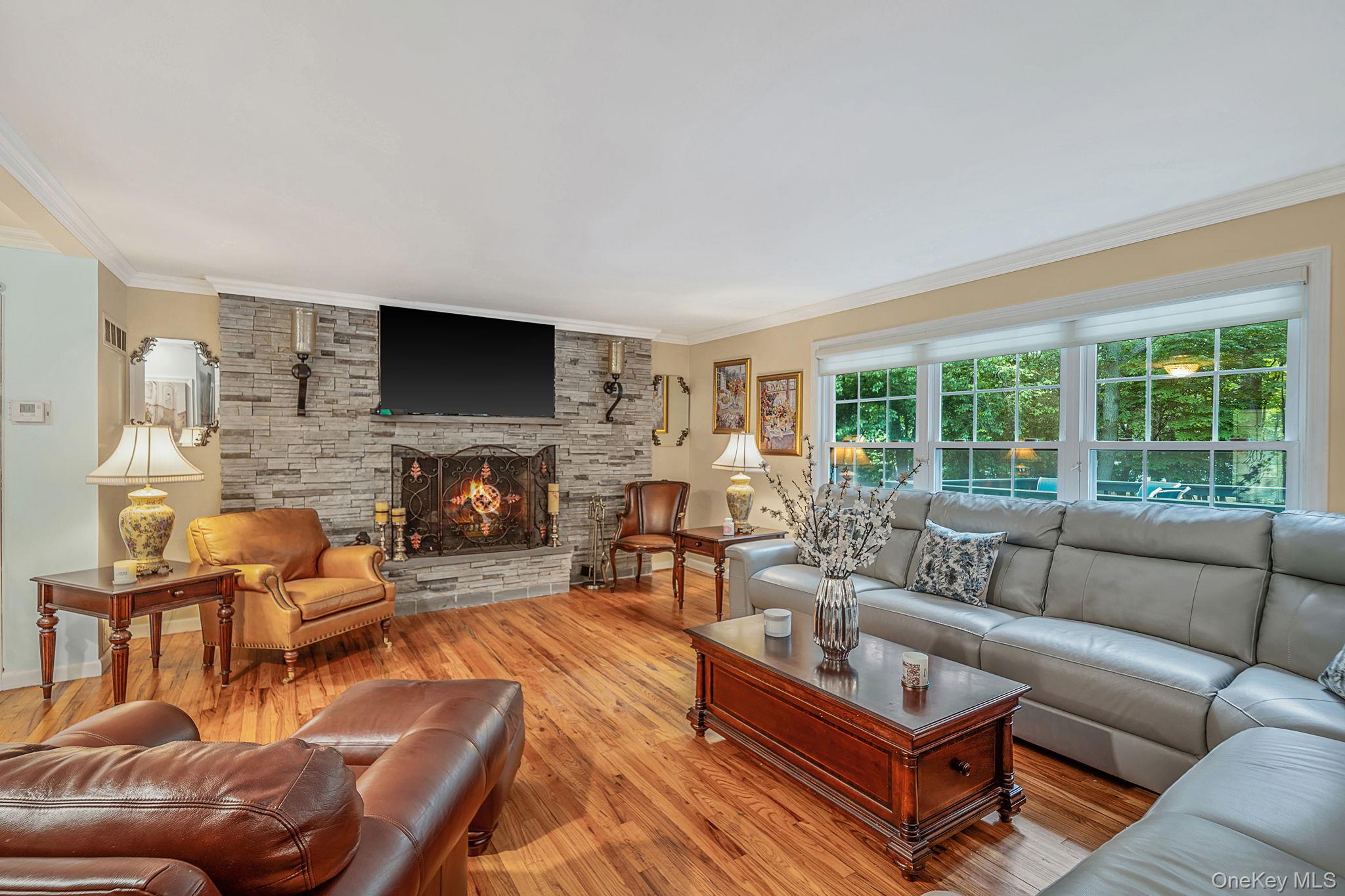 15 Cliff Road Port Jefferson, NY 11777 - Photo 5 of 38 Elegant space with wood floors, wood burning, stone faced fireplace