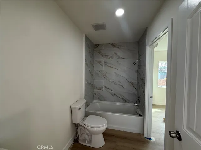 a bathroom with a bathtub and toilet