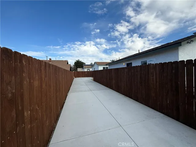 a view of outside space with wooden fence