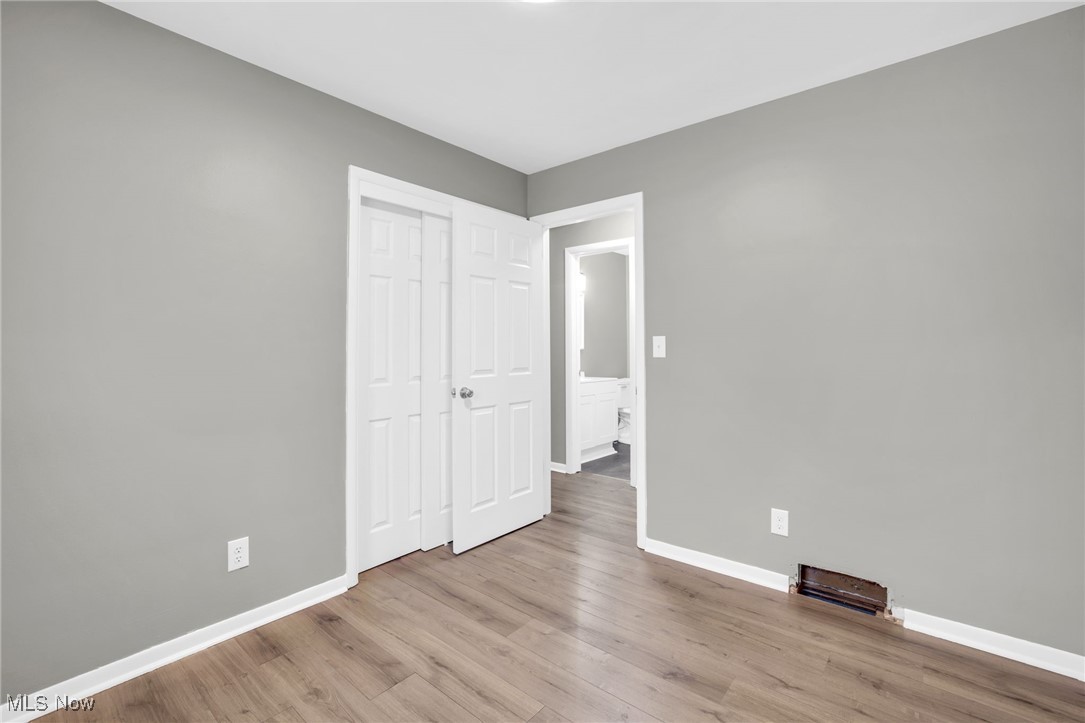 3930 Wadsworth Road Barberton, OH 44203 - Photo 18 of 30 Unfurnished bedroom with a closet and light wood-style flooring