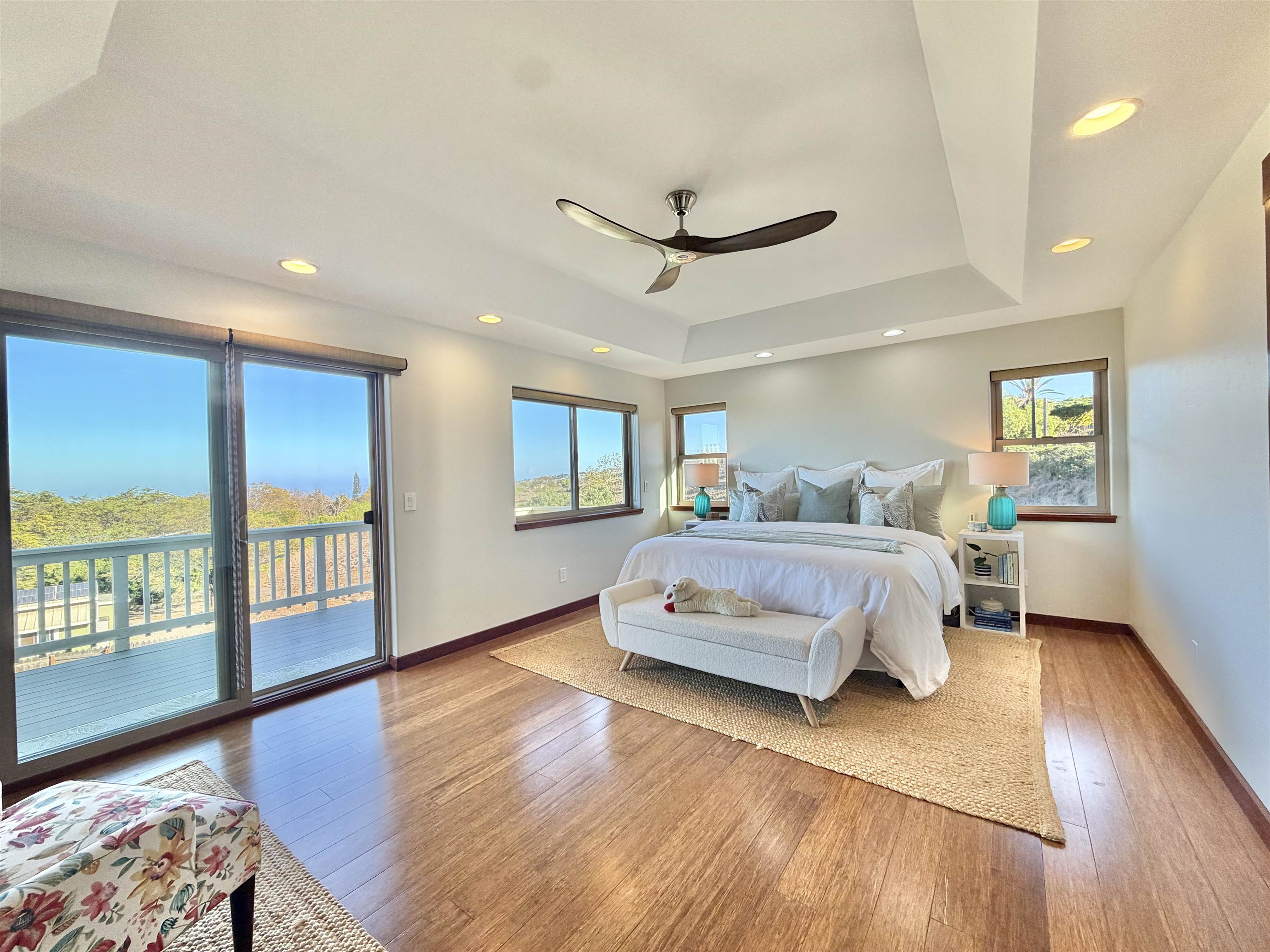 1350 Naalae Road Kula, HI 96790 - Photo 14 of 50 a spacious bedroom with a bed a dresser and wooden floor