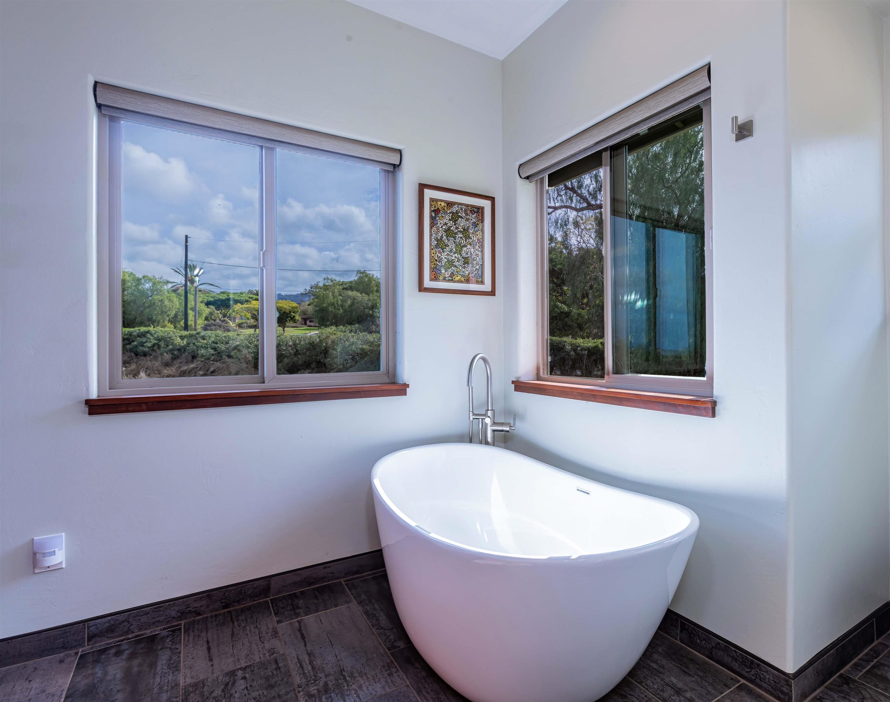 1350 Naalae Road Kula, HI 96790 - Photo 18 of 50 a white bath tub sitting in a bathroom next to a window