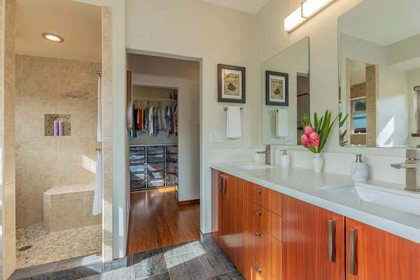 a bathroom with a double vanity sink and a large mirror