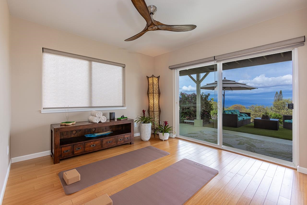 1350 Naalae Road Kula, HI 96790 - Photo 24 of 50 a living room with furniture and a floor to ceiling window