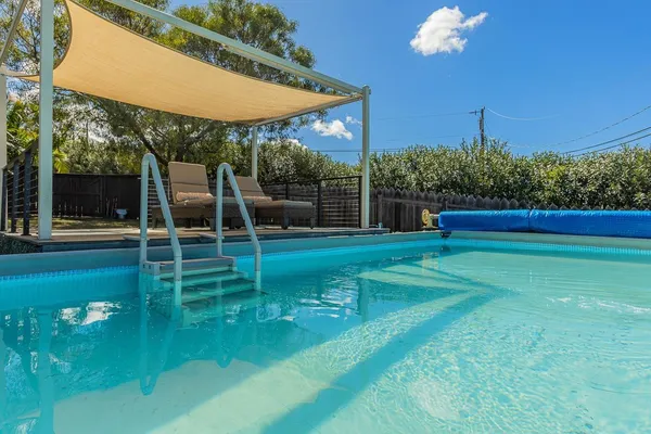 a view of a chair and tables in the back yard