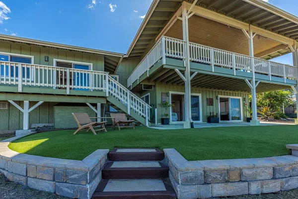 a view of a house with a yard porch and sitting area