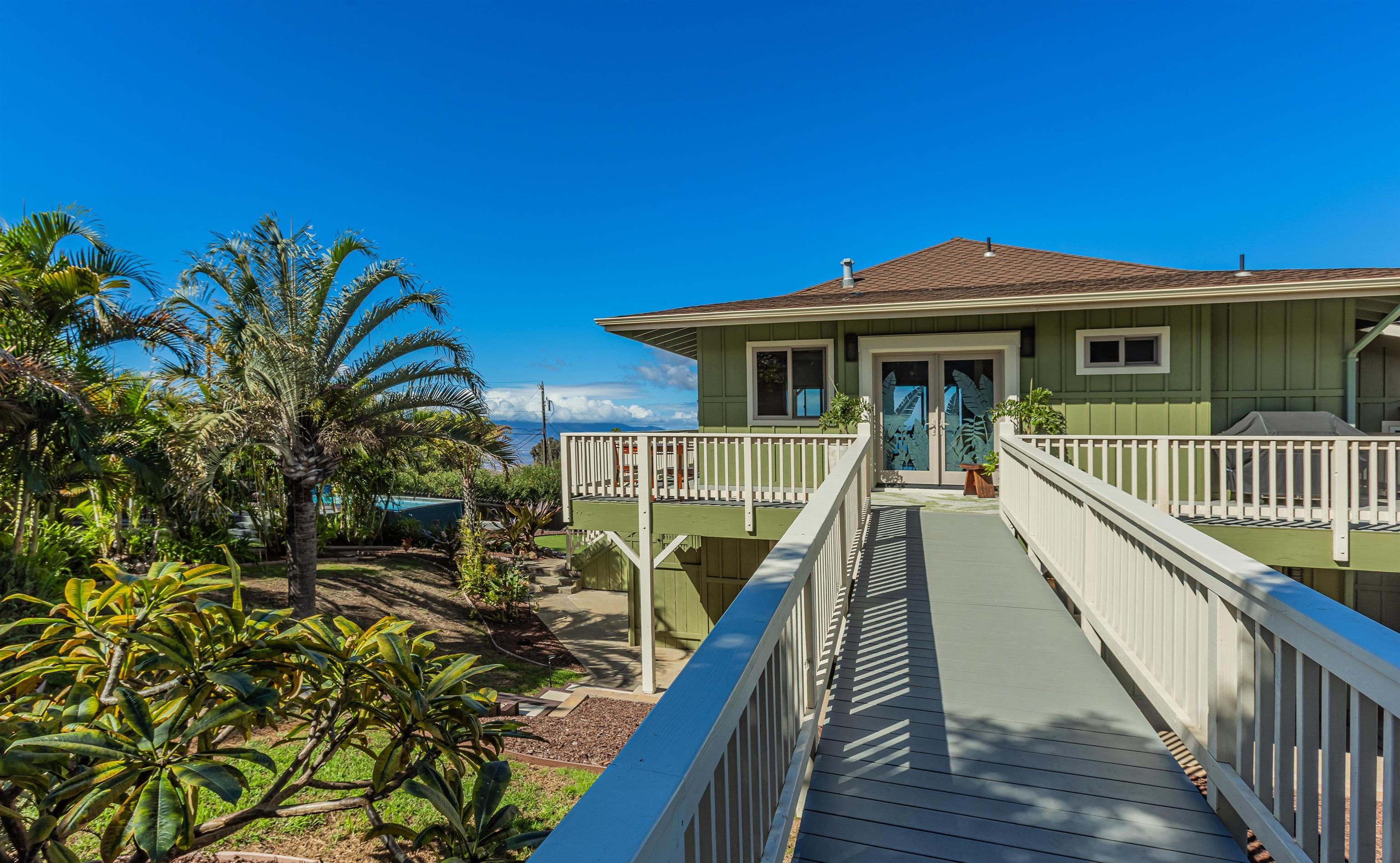 1350 Naalae Road Kula, HI 96790 - Photo 7 of 50 a view of a house with wooden deck