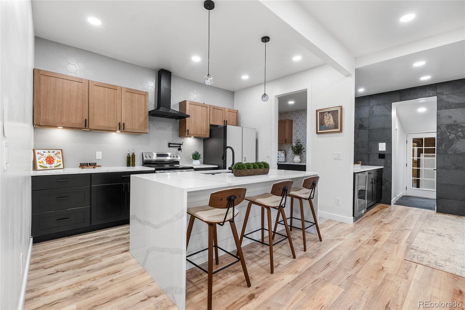 2011 West Scott Place Denver, CO 80211 - Photo 11 of 46 a kitchen with stainless steel appliances granite countertop a sink a stove a refrigerator cabinets and chairs