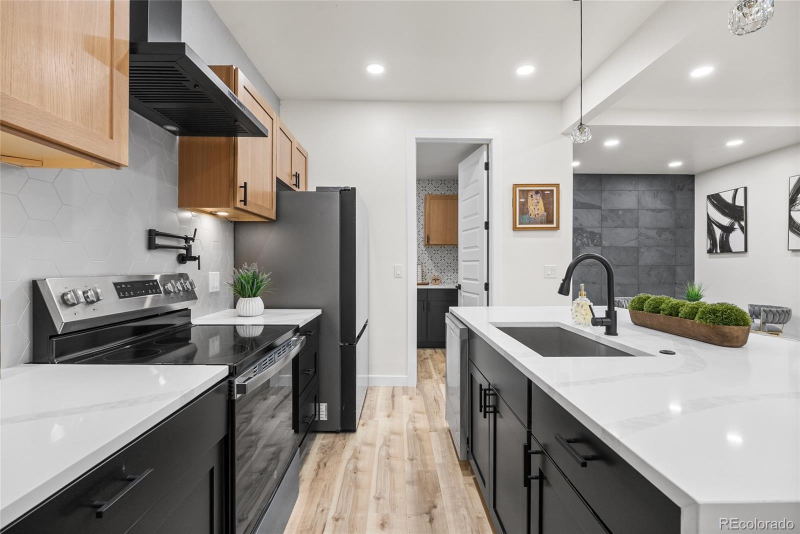 2011 West Scott Place Denver, CO 80211 - Photo 12 of 46 a kitchen with stainless steel appliances a sink stove and cabinets