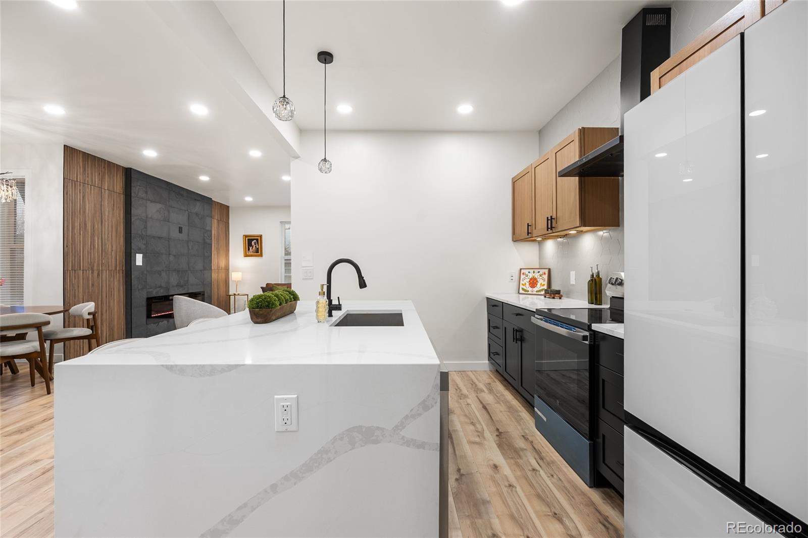 2011 West Scott Place Denver, CO 80211 - Photo 14 of 46 a kitchen with stainless steel appliances a sink dishwasher a refrigerator and a stove with wooden floor