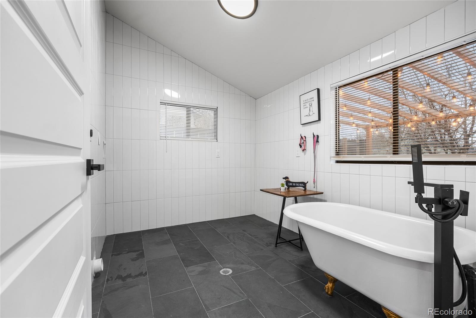 2011 West Scott Place Denver, CO 80211 - Photo 18 of 46 a bathroom with a bathtub and a shower