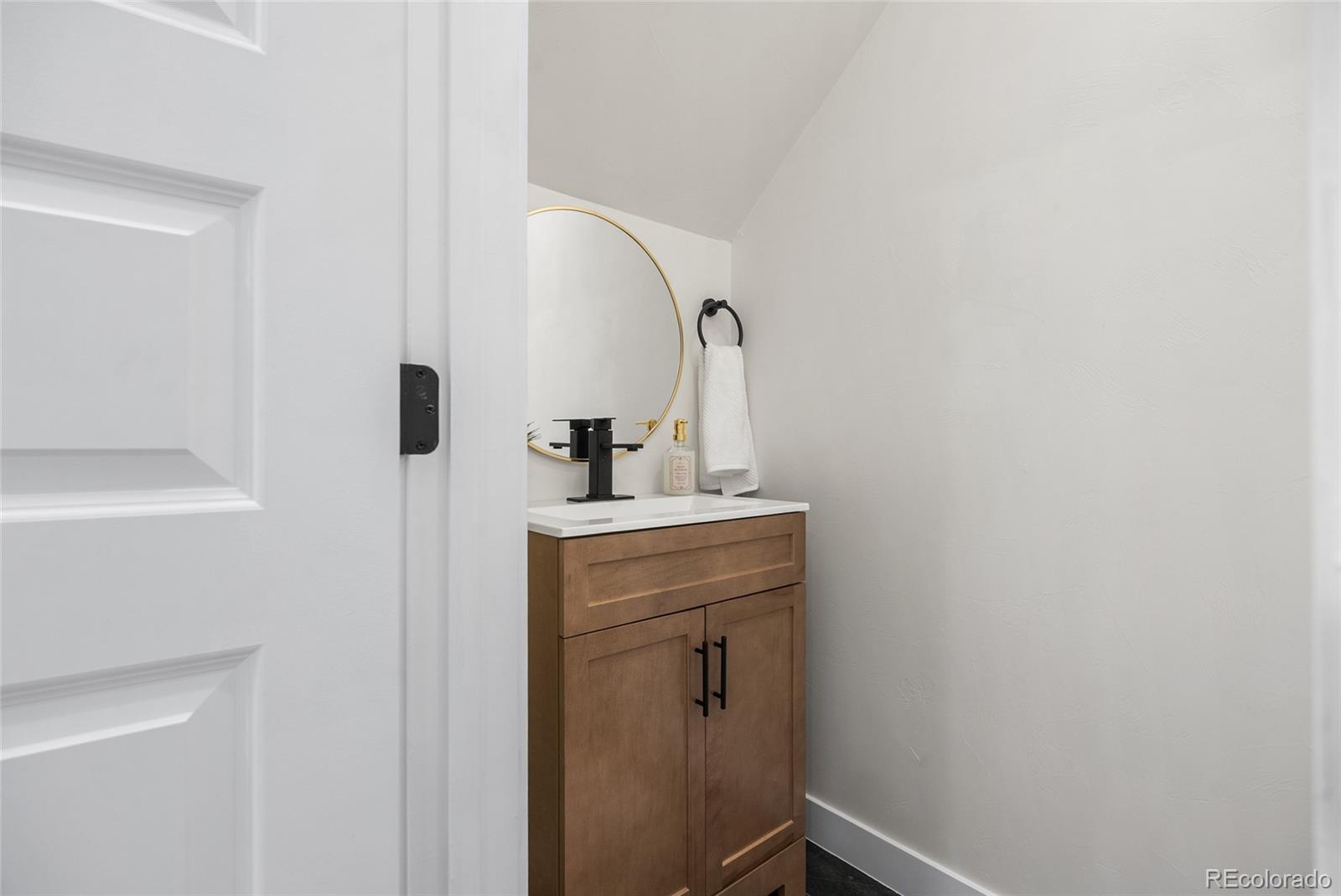 2011 West Scott Place Denver, CO 80211 - Photo 20 of 46 a room with a sink and a mirror