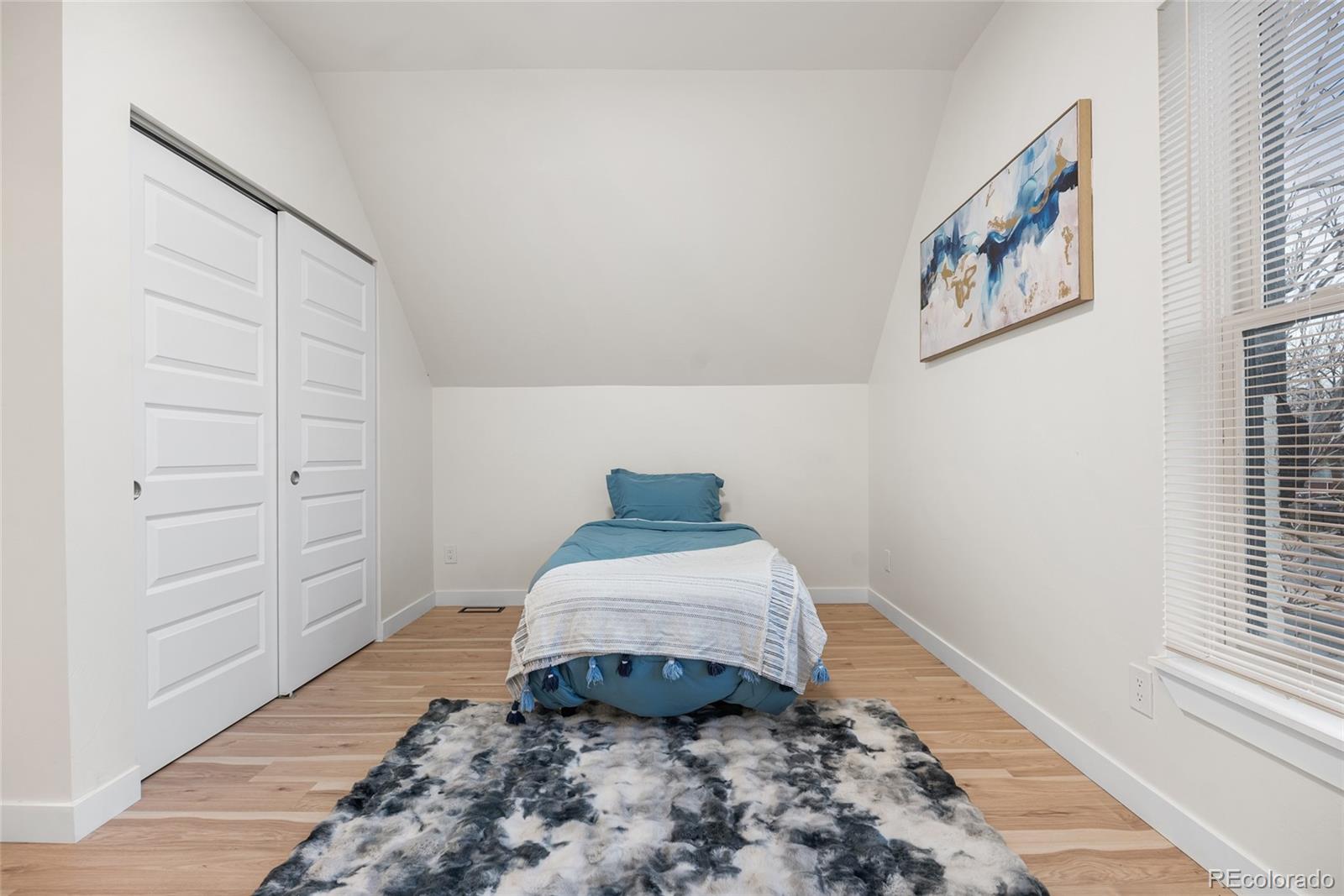 2011 West Scott Place Denver, CO 80211 - Photo 22 of 46 a room with painting on the wall and a window