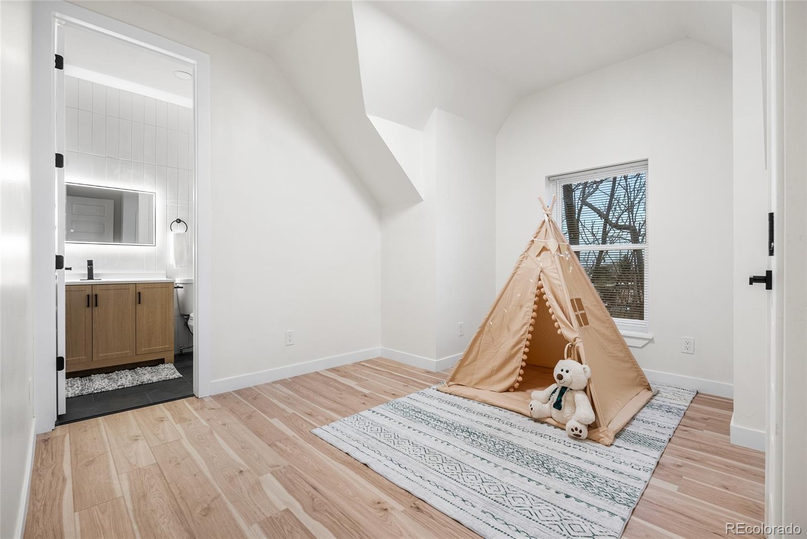 2011 West Scott Place Denver, CO 80211 - Photo 26 of 46 a view of a bedroom with wooden floor and a bathroom