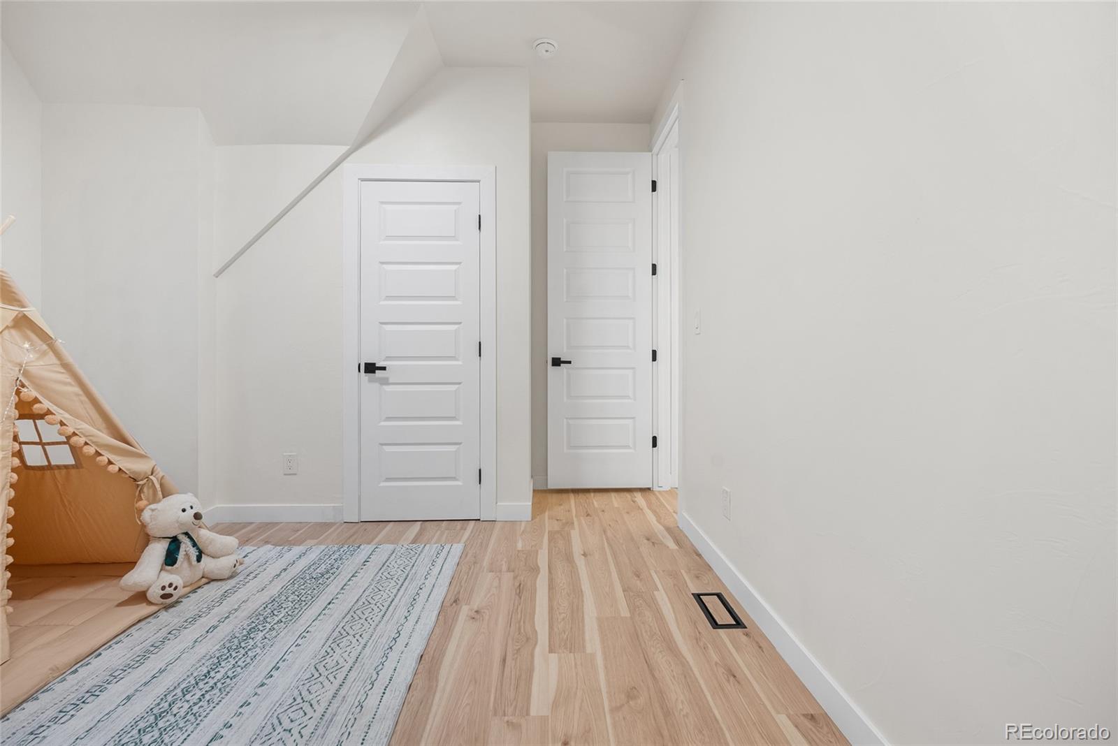 2011 West Scott Place Denver, CO 80211 - Photo 27 of 46 a view of a hallway with wooden floor and staircase