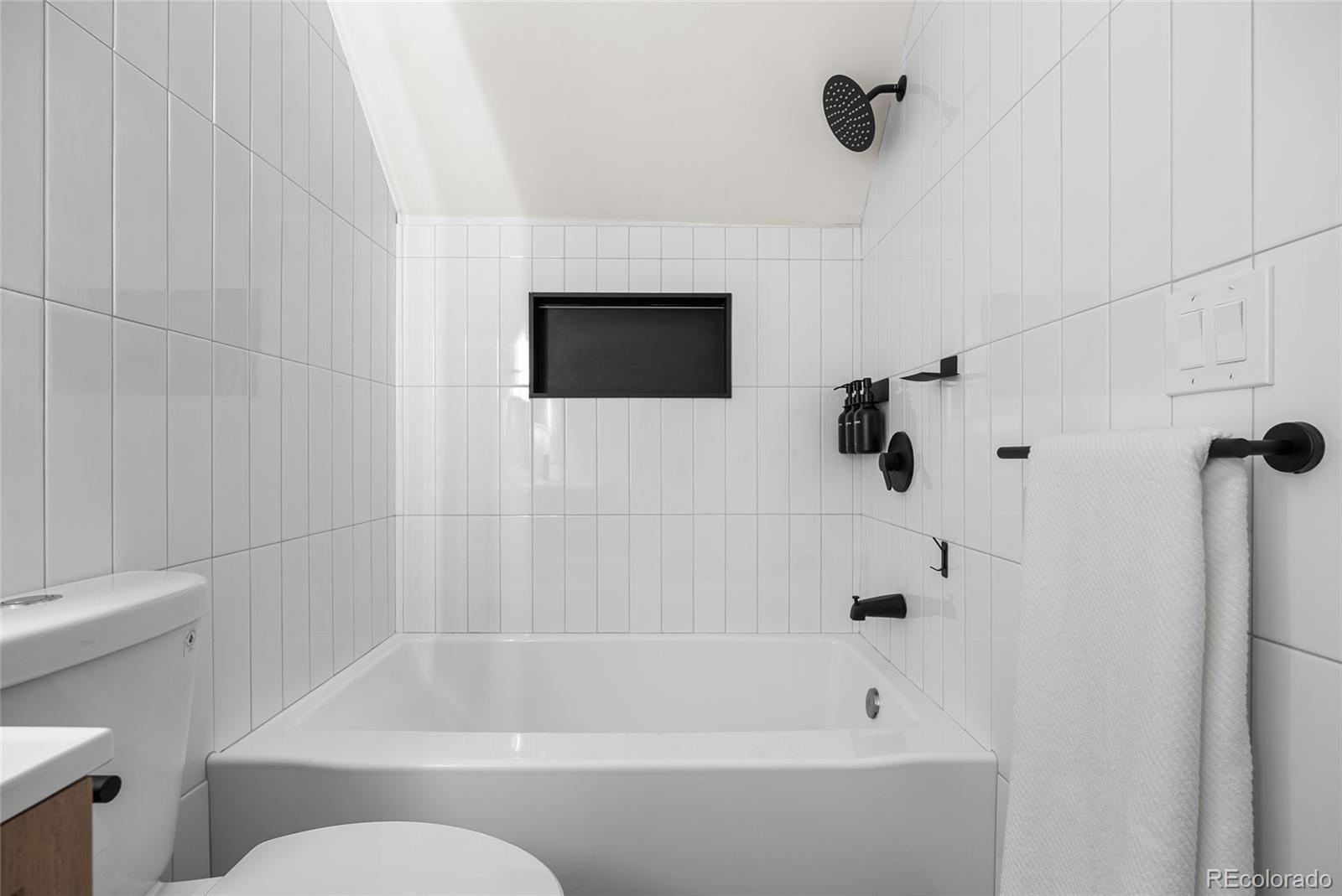 2011 West Scott Place Denver, CO 80211 - Photo 29 of 46 a bathroom with a bathtub and a shower