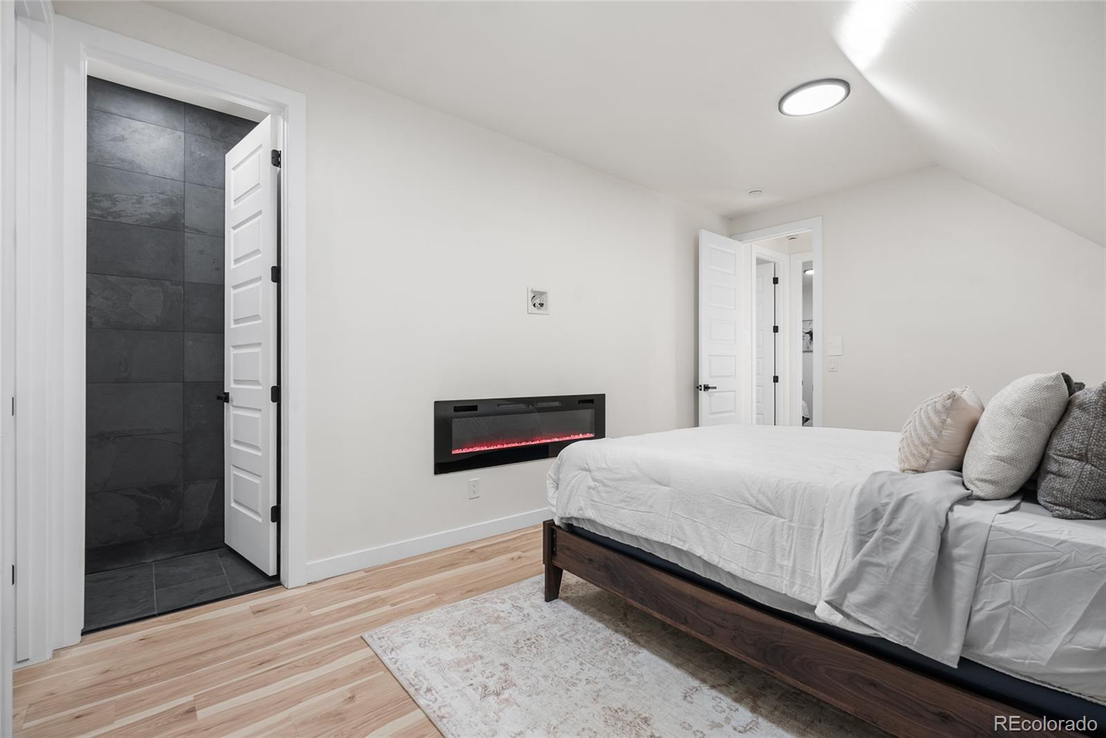 2011 West Scott Place Denver, CO 80211 - Photo 31 of 46 a bedroom with a bed and a mirror