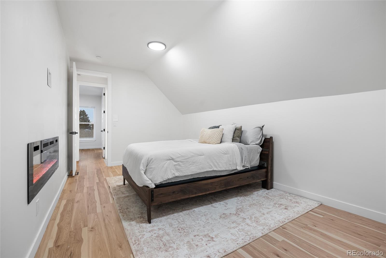 2011 West Scott Place Denver, CO 80211 - Photo 32 of 46 a bedroom with a bed and a wooden floor