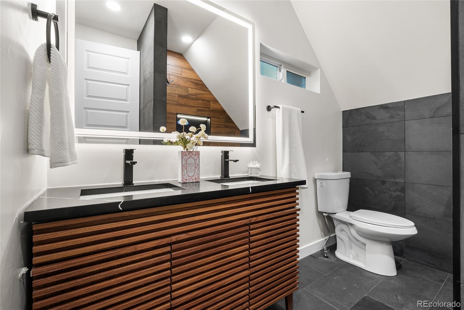2011 West Scott Place Denver, CO 80211 - Photo 33 of 46 a bathroom with a sink a toilet and a window