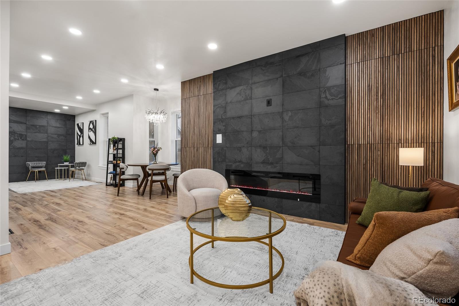 2011 West Scott Place Denver, CO 80211 - Photo 6 of 46 a living room with furniture a dining table and a fireplace