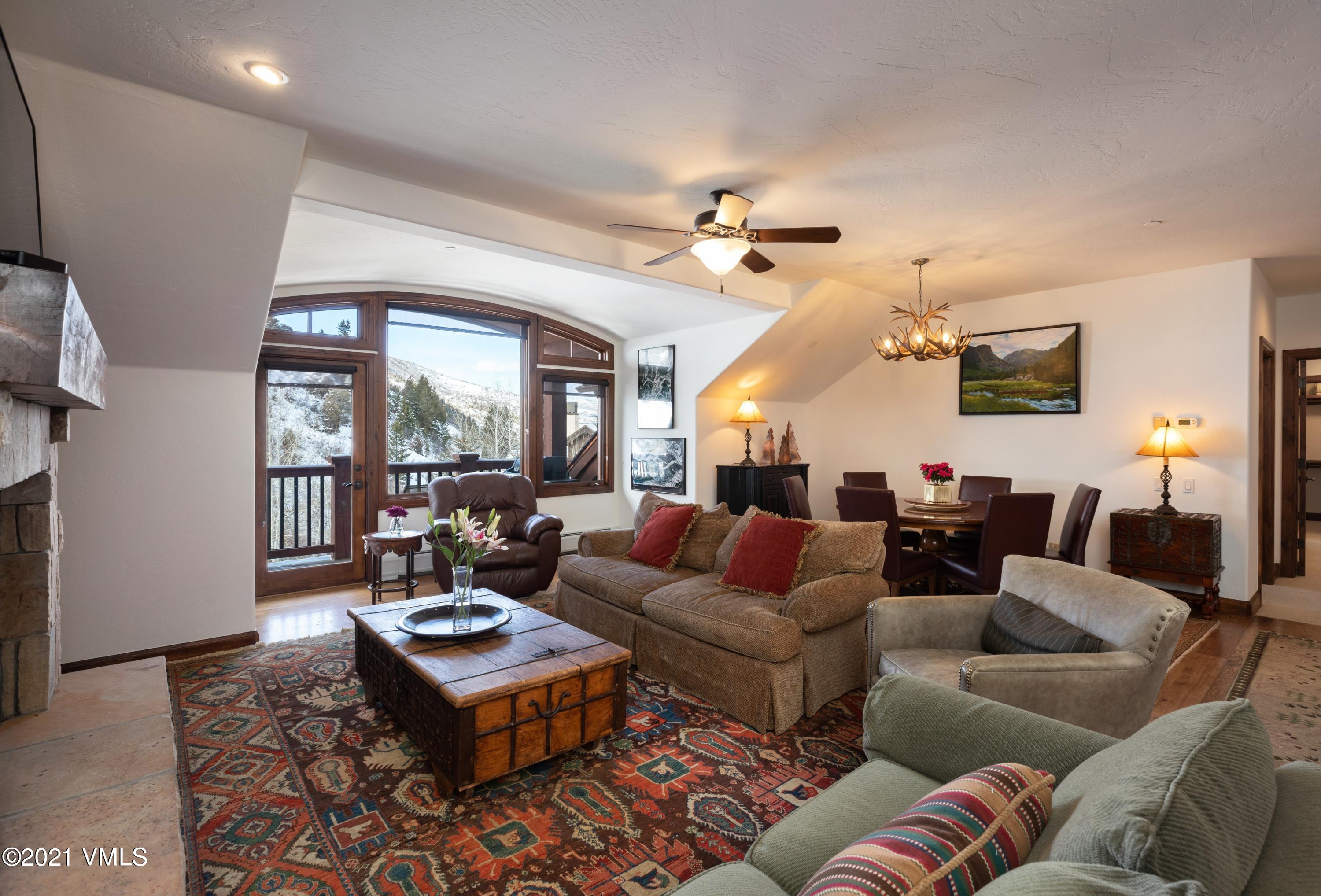 160 Cresta Road, Unit R402 Edwards, CO 81632 - Photo 1 of 8 a living room with furniture and a large window