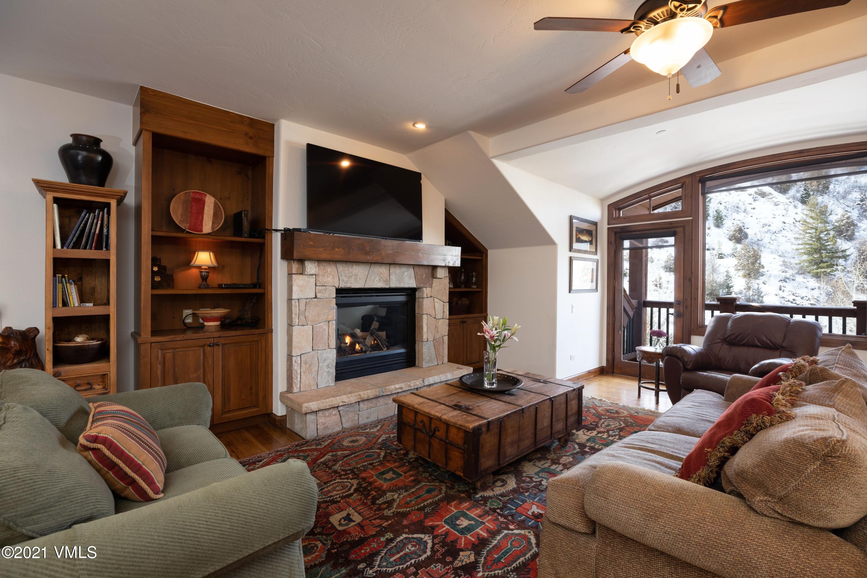 160 Cresta Road, Unit R402 Edwards, CO 81632 - Photo 2 of 8 a living room with furniture fireplace and flat screen tv