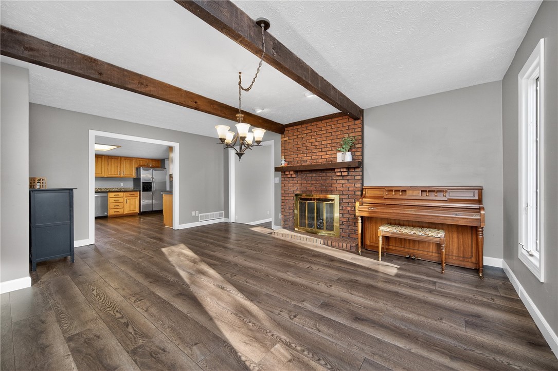 4747 Fawnwood Road Dayton, OH 45429 - Photo 13 of 58 This inviting living space features warm hardwood floors, a cozy brick fireplace, and an adjoining kitchen.