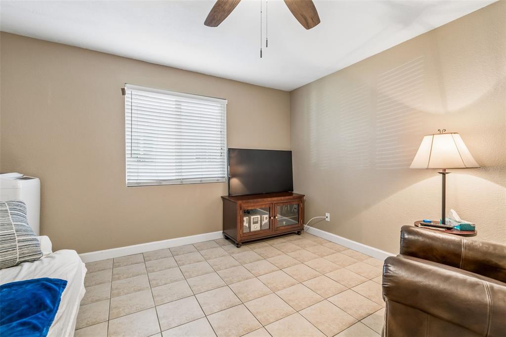 229 Red Maple Place Brandon, FL 33510 - Photo 11 of 45 a living room with a couch and a flat screen tv