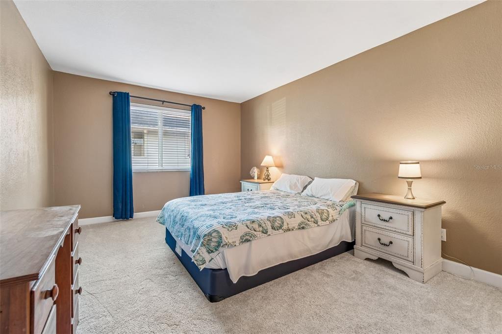 229 Red Maple Place Brandon, FL 33510 - Photo 12 of 45 a bedroom with a bed and a night stand