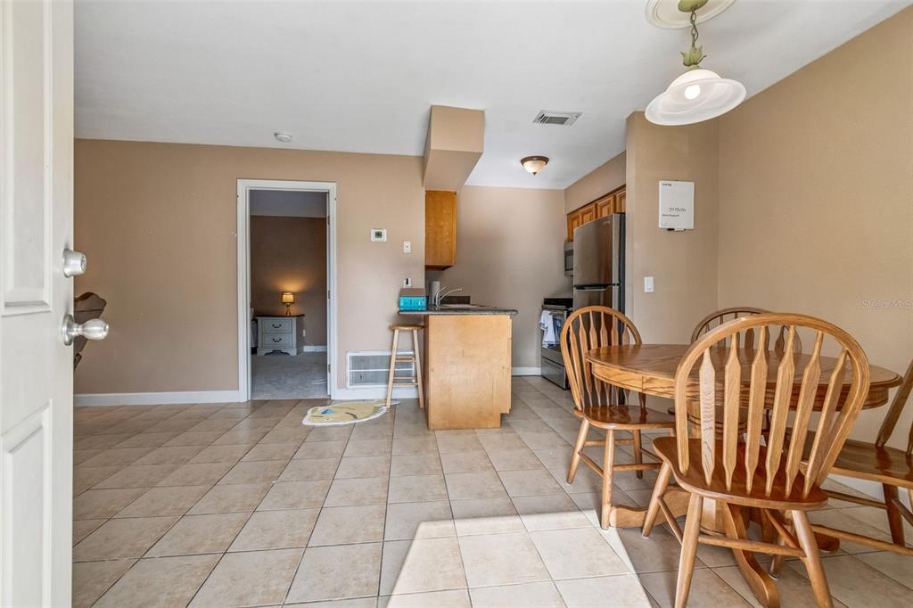 229 Red Maple Place Brandon, FL 33510 - Photo 5 of 45 a view of a dining room with furniture and wooden floor
