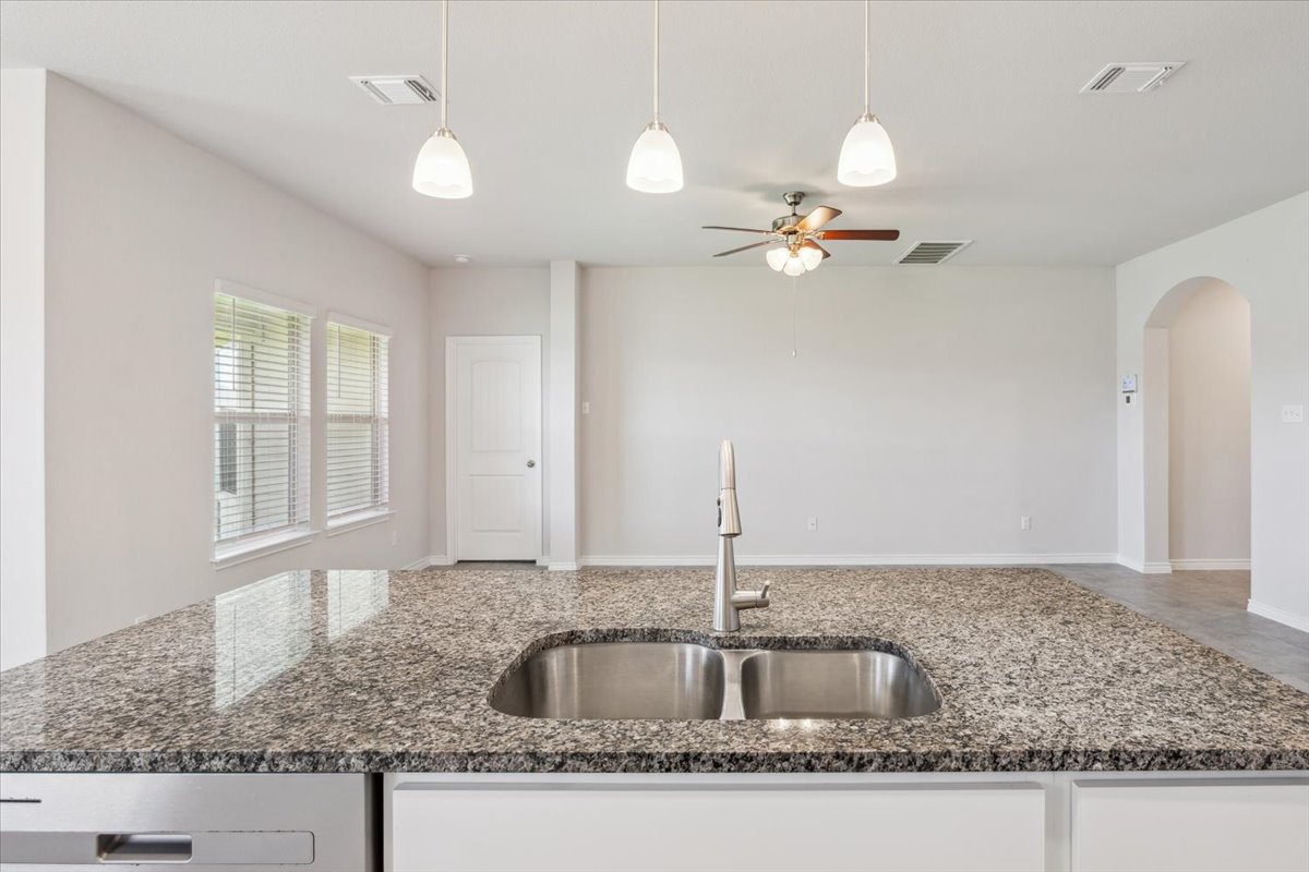 5830 Copano Road Belton, TX 76513 - Photo 17 of 34 Kitchen with a sink, visible vents, ceiling fan, and arched walkways