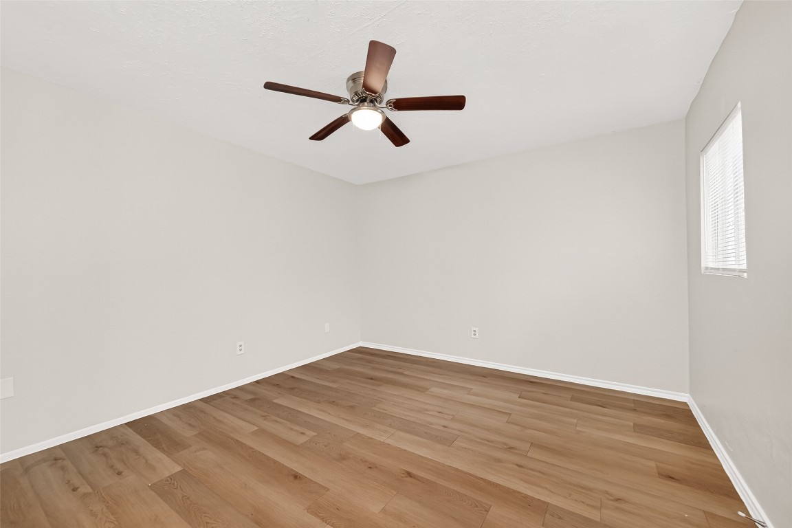 17421 Ranch Country Road Hockley, TX 77447 - Photo 14 of 28 a view of empty room with wooden floor