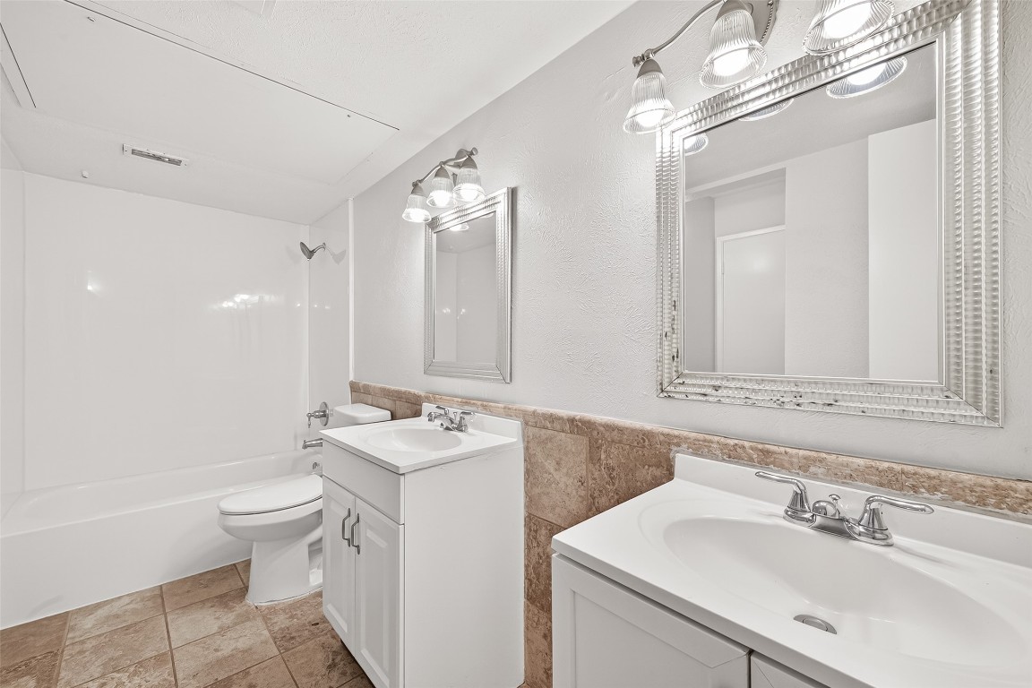 17421 Ranch Country Road Hockley, TX 77447 - Photo 21 of 28 a bathroom with a sink a toilet a mirror and shower