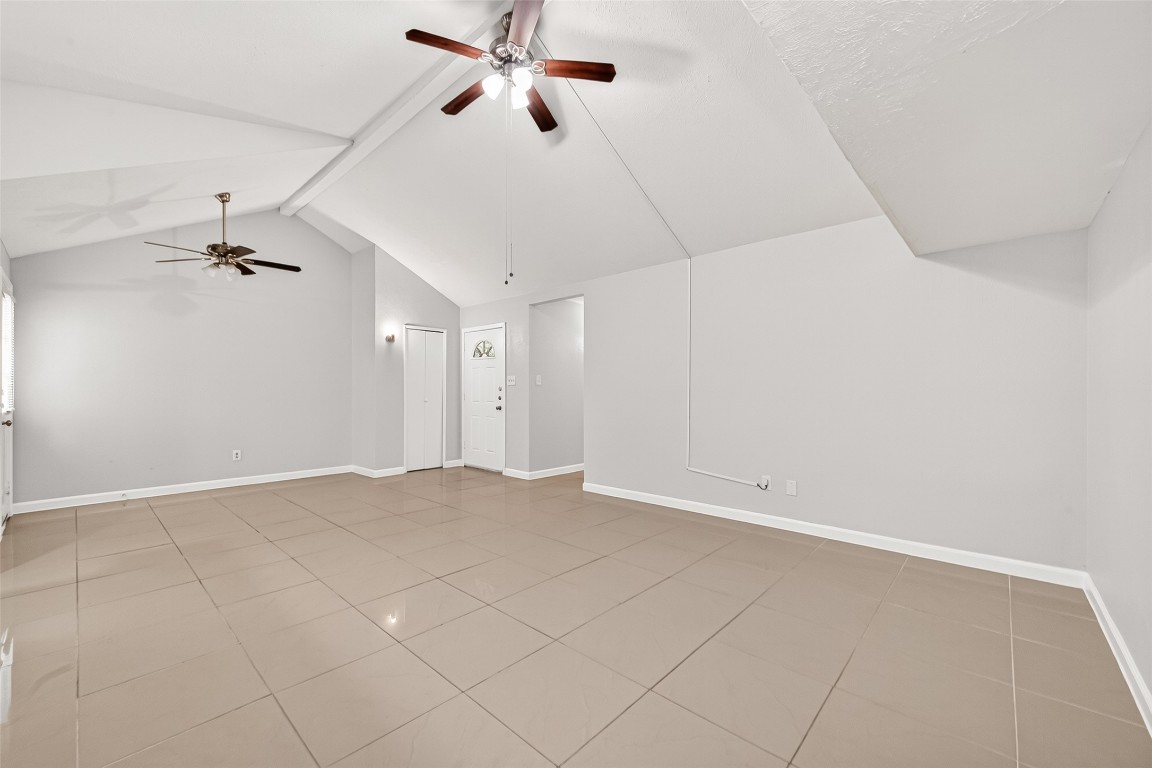 17421 Ranch Country Road Hockley, TX 77447 - Photo 8 of 28 an empty room with chandelier fan and windows