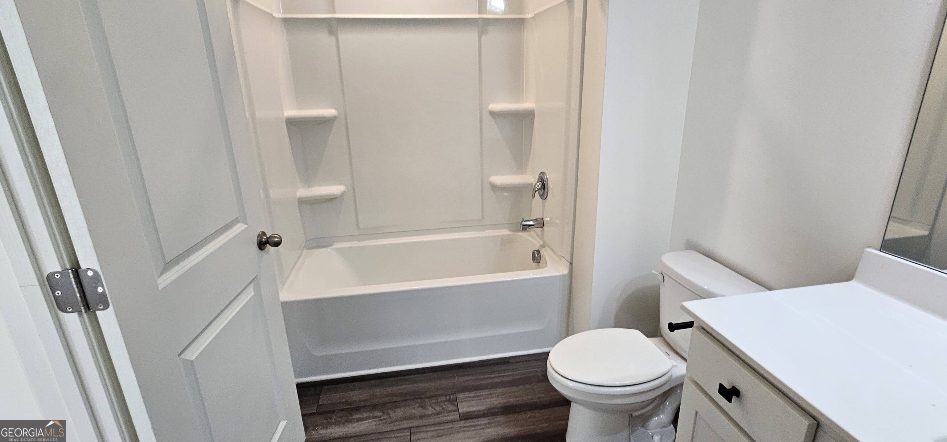 3488 Cardinal Drive Southwest Atlanta, GA 30331 - Photo 13 of 24 a white toilet sitting next to a bath tub