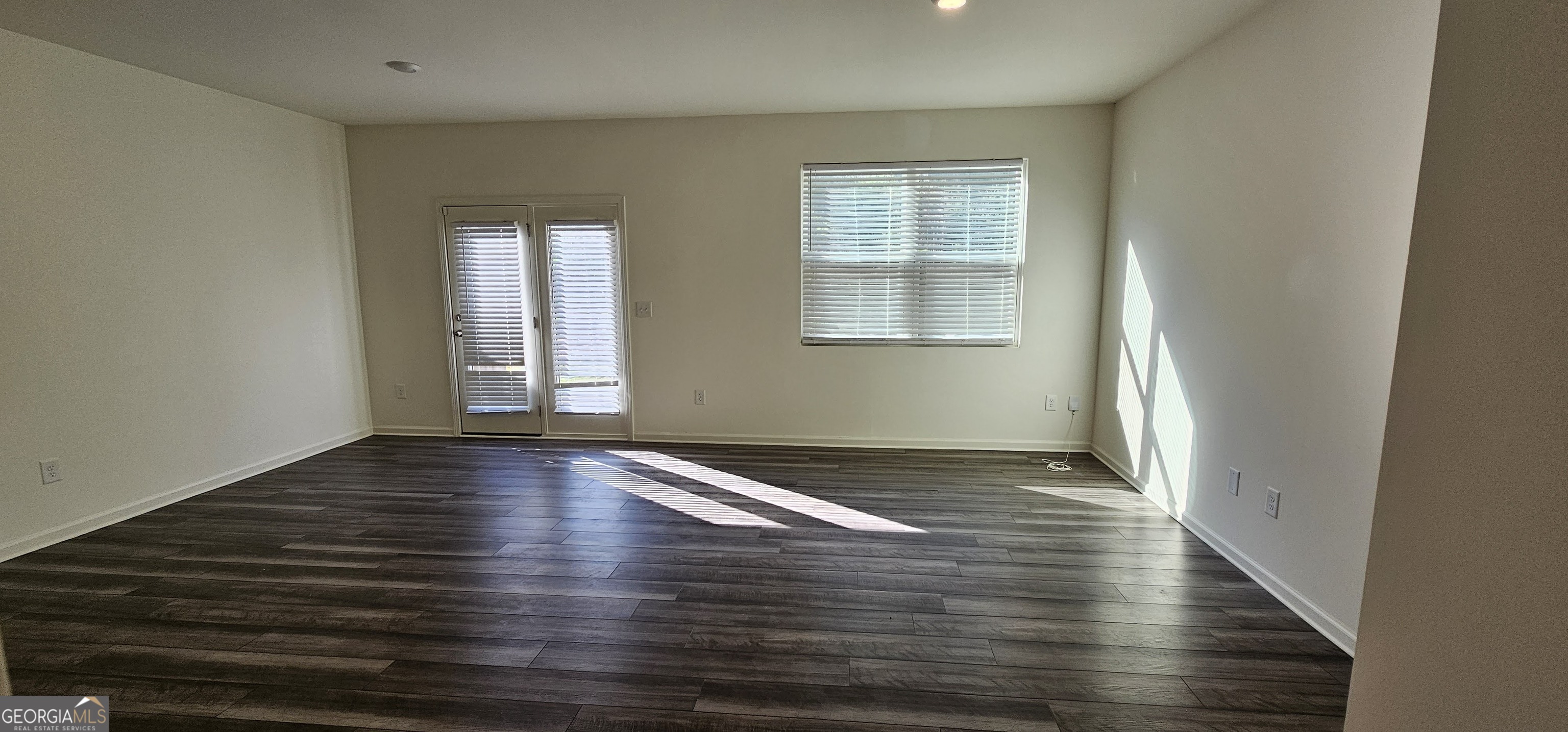 3488 Cardinal Drive Southwest Atlanta, GA 30331 - Photo 4 of 24 wooden floor in an empty room with a window