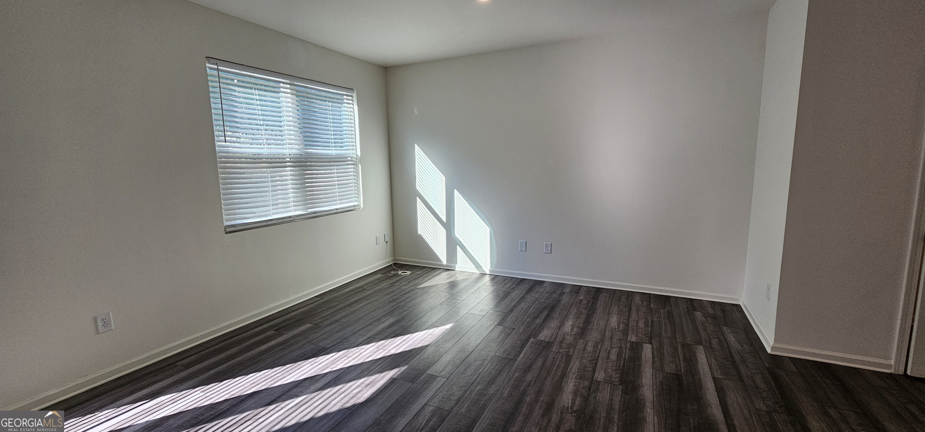 3488 Cardinal Drive Southwest Atlanta, GA 30331 - Photo 5 of 24 a view of an empty room with wooden floor and a window
