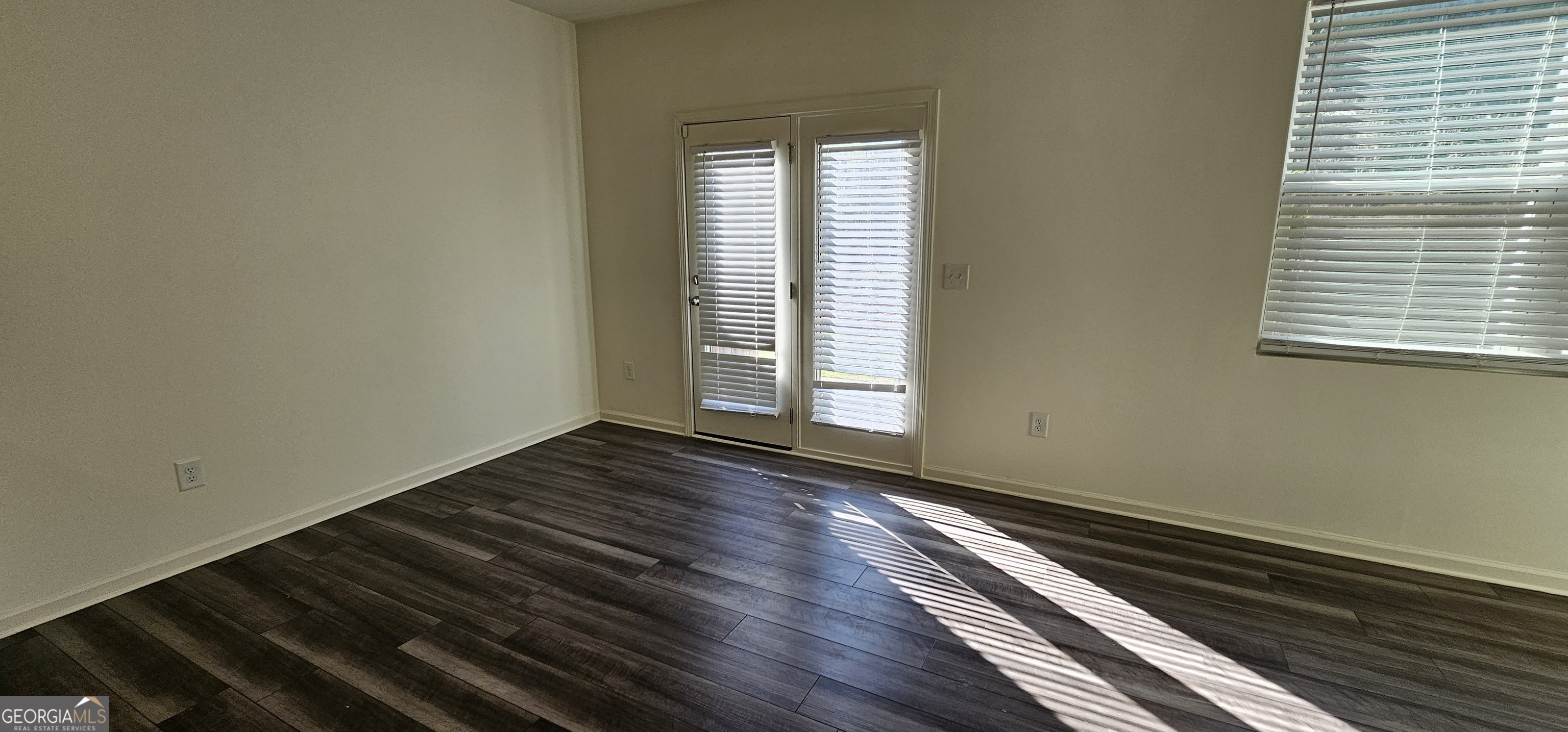 3488 Cardinal Drive Southwest Atlanta, GA 30331 - Photo 6 of 24 a view of an empty room with wooden floor and a window