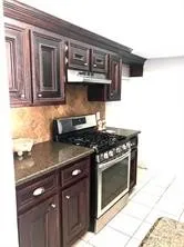 a kitchen with stainless steel appliances granite countertop a stove and a sink