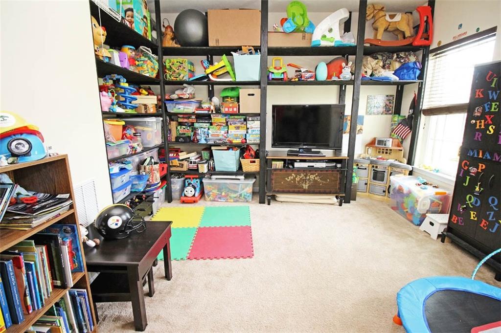 507 Saddle Ridge Court Irwin, PA 15642 - Photo 9 of 24 Formal living room currently used as a playroom. Shelving can be easily removed.
