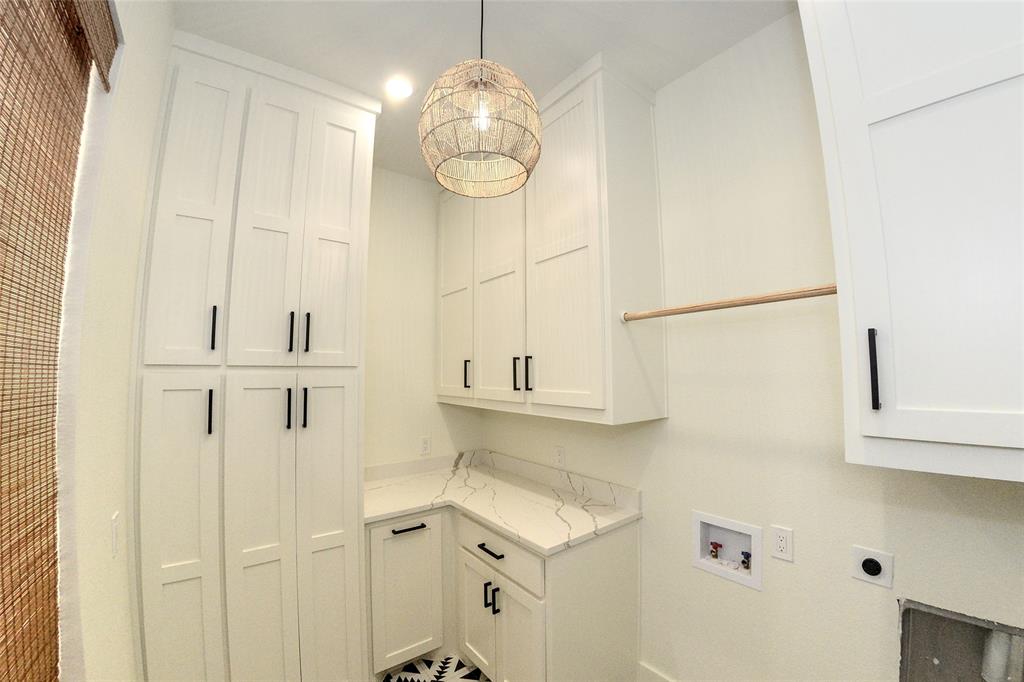 1805 Arthur Road Denison, TX 75021 - Photo 12 of 31 Laundry area full of cabinets and a laundry shoot hidden inside one.