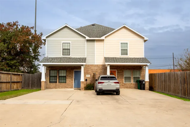 a car parked in front of white house