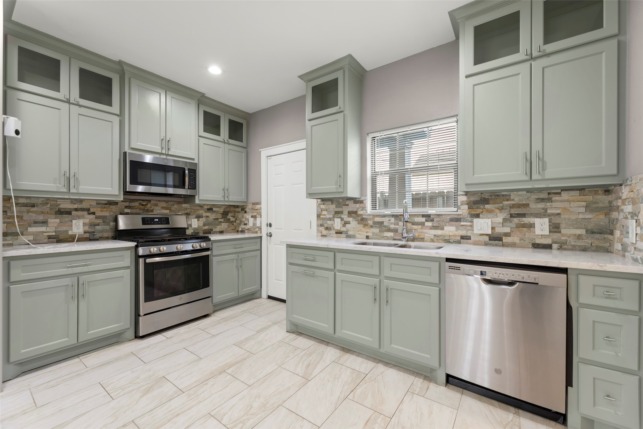 6501 Stratton Street Houston, TX 77023 - Photo 12 of 29 a kitchen with cabinets appliances and a sink