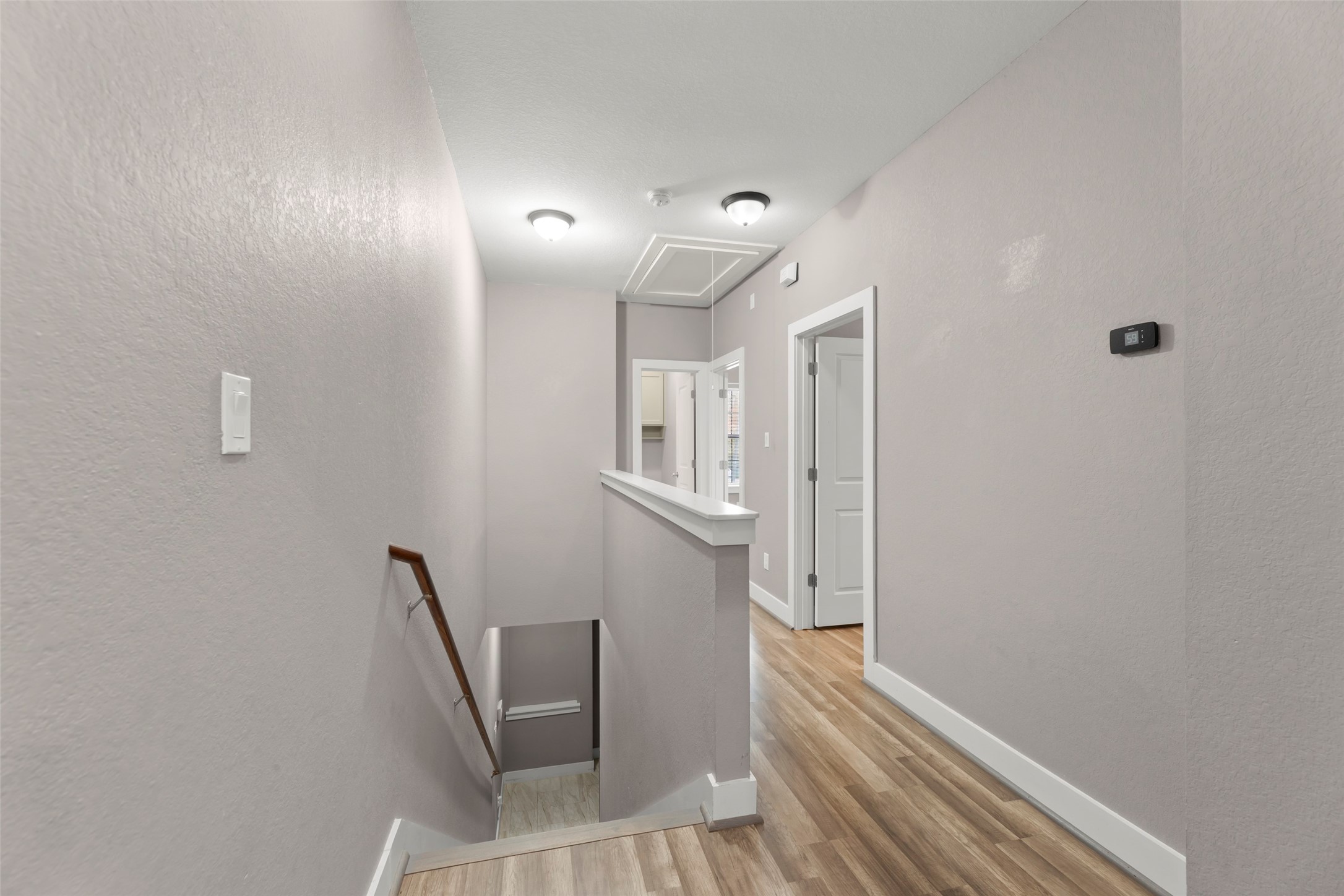 6501 Stratton Street Houston, TX 77023 - Photo 20 of 29 a view of a hallway to a room with wooden floor and windows