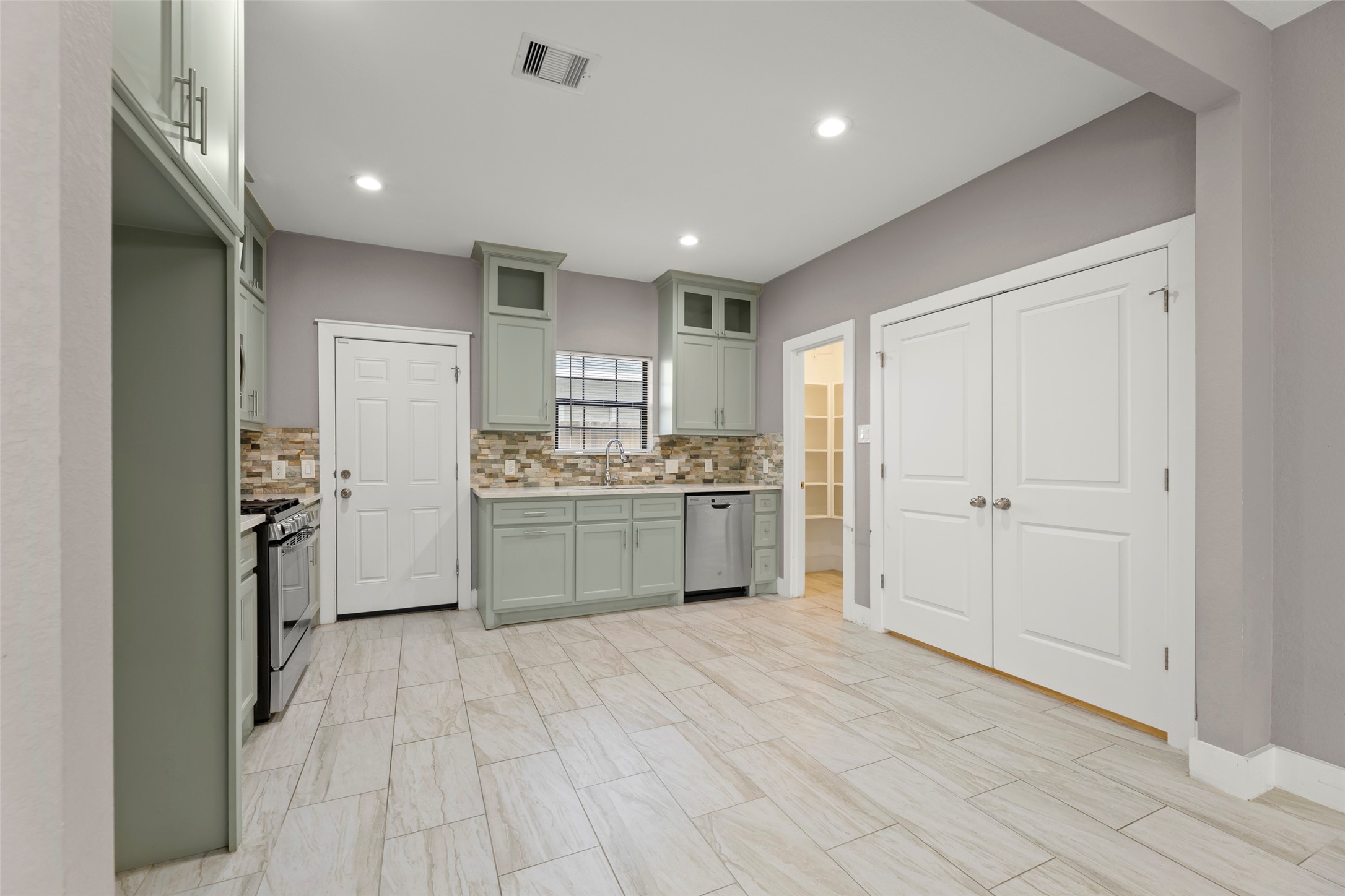 6501 Stratton Street Houston, TX 77023 - Photo 3 of 29 a kitchen with white cabinets and white appliances