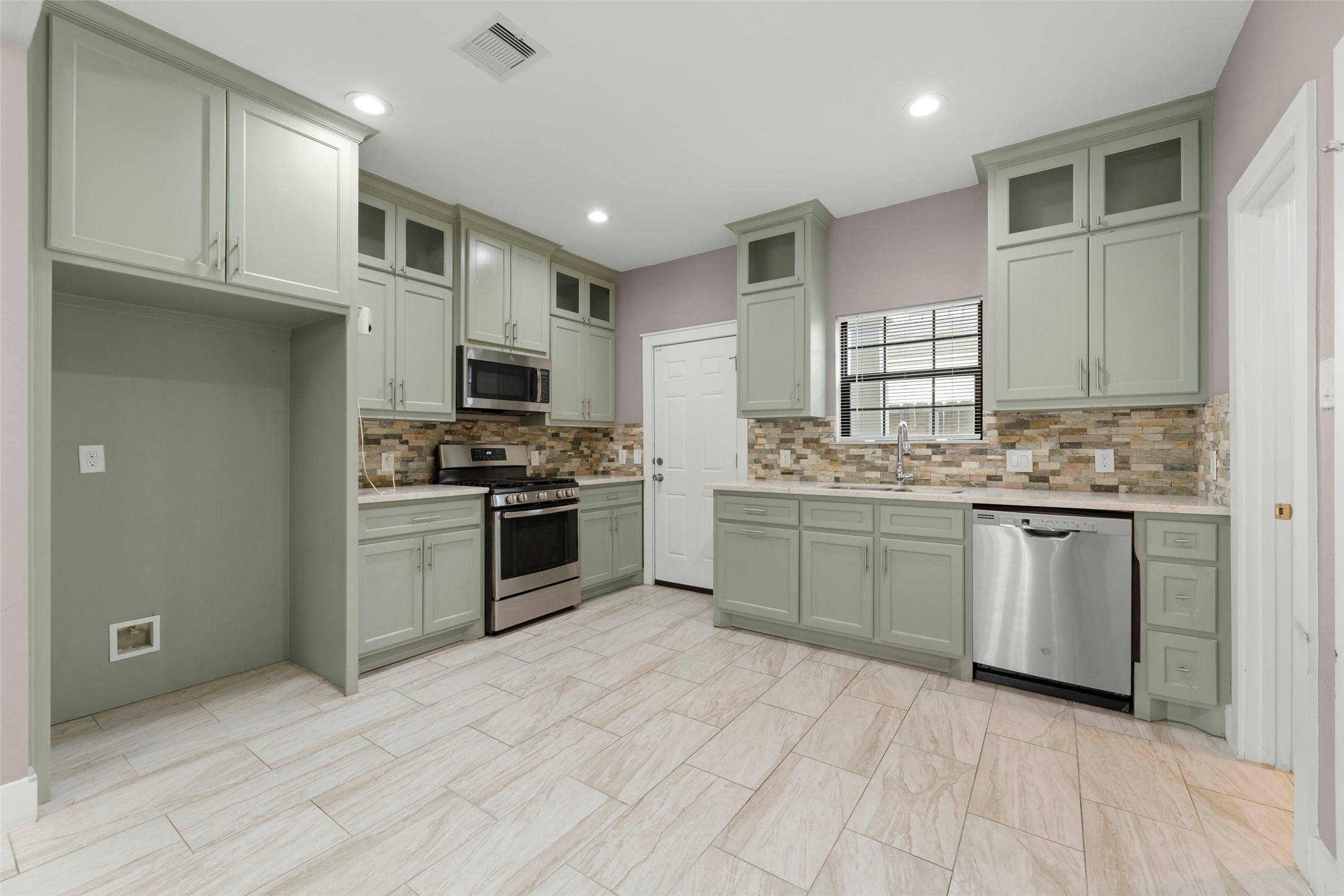 6501 Stratton Street Houston, TX 77023 - Photo 4 of 29 a kitchen with granite countertop a sink stainless steel appliances and cabinets