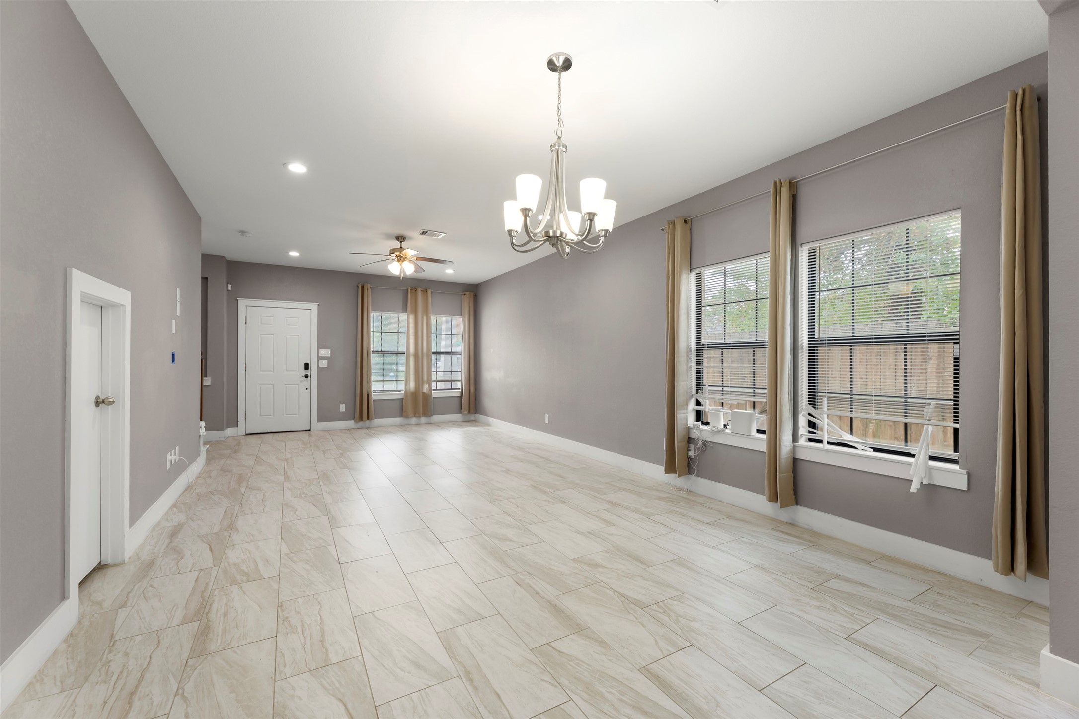 6501 Stratton Street Houston, TX 77023 - Photo 9 of 29 a view of a livingroom with a chandelier fan and windows