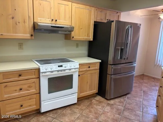 a kitchen with appliances cabinets and a window