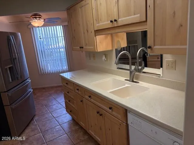 a kitchen with granite countertop a sink stainless steel appliances and cabinets